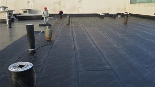 Finished SBS waterproofing membrane surface with offset laps visible across the roof