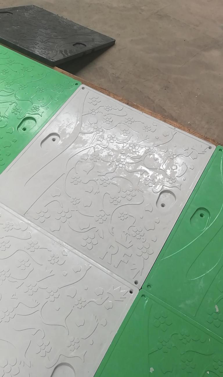 Green and white manhole cover sample