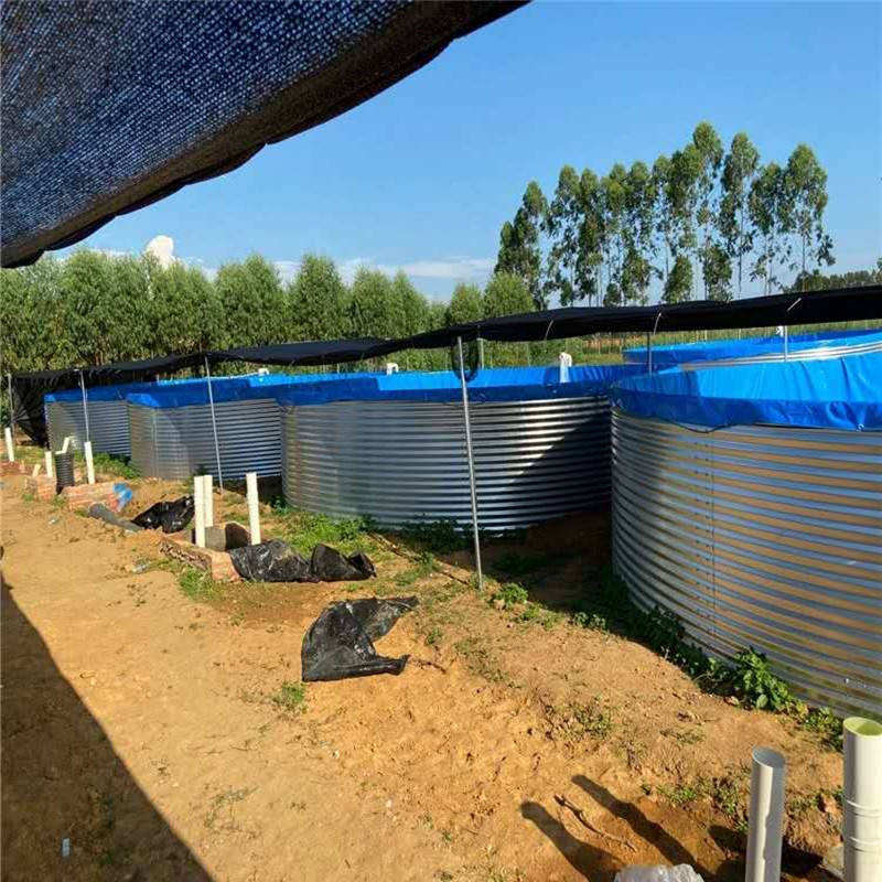 Galvanized canvas fish pond in operation with inlet and outlet pipework connected